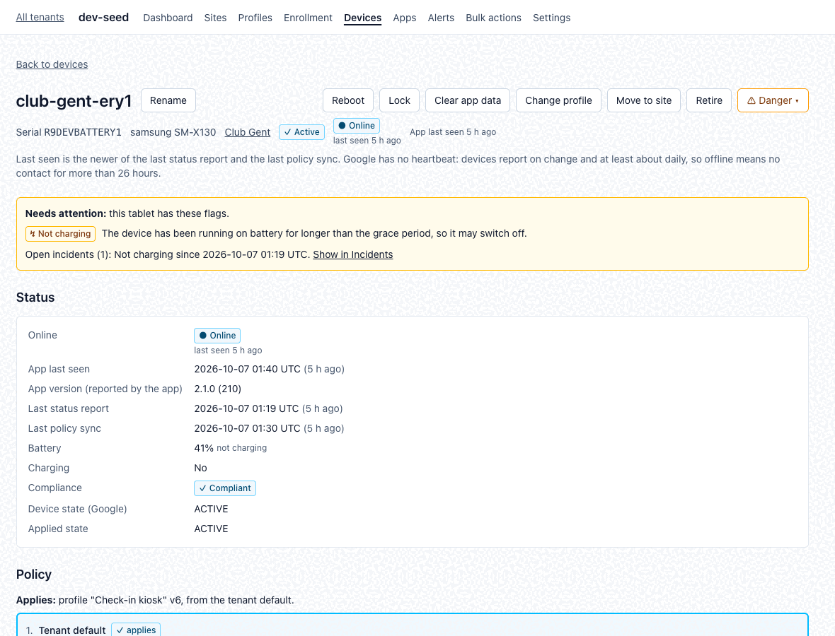 A device page with its actions bar, an attention banner, status details and the applied policy